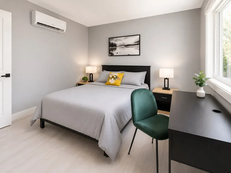 Bright Langley suite bedroom with a green velvet desk chair